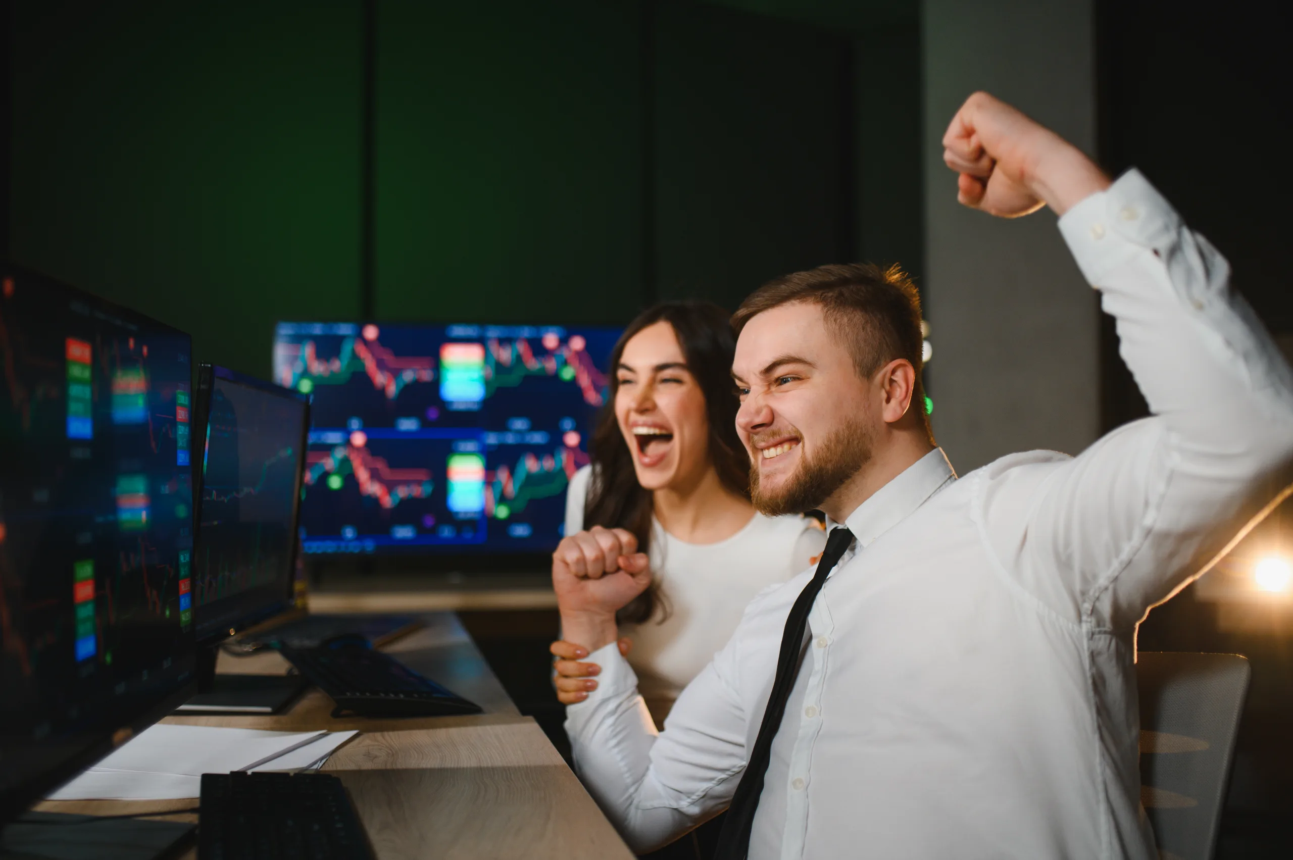 Traders celebrating financial success watching cryptocurrency stock market charts