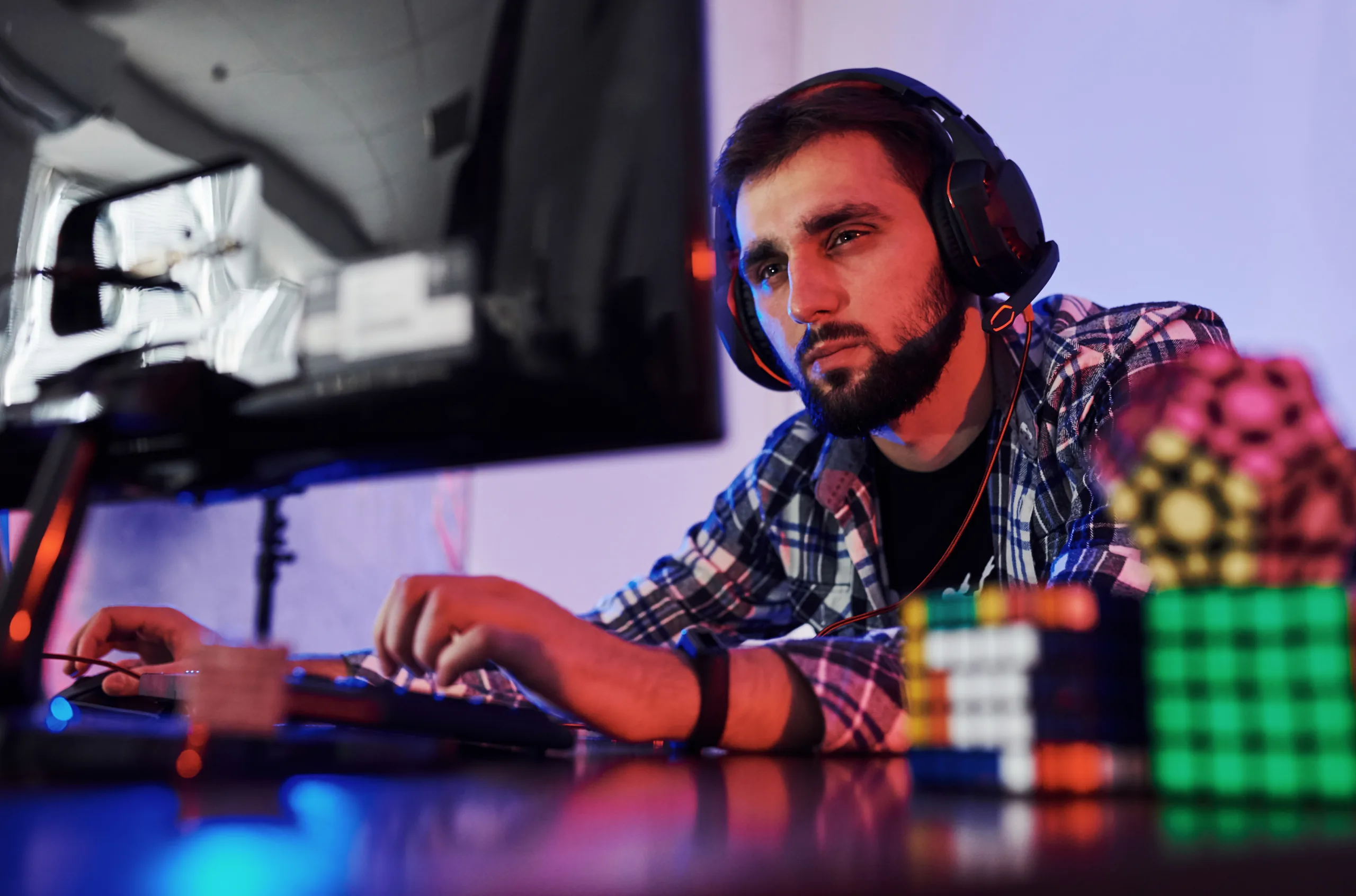 Portrait of young bearded pro gamer playing in online video game