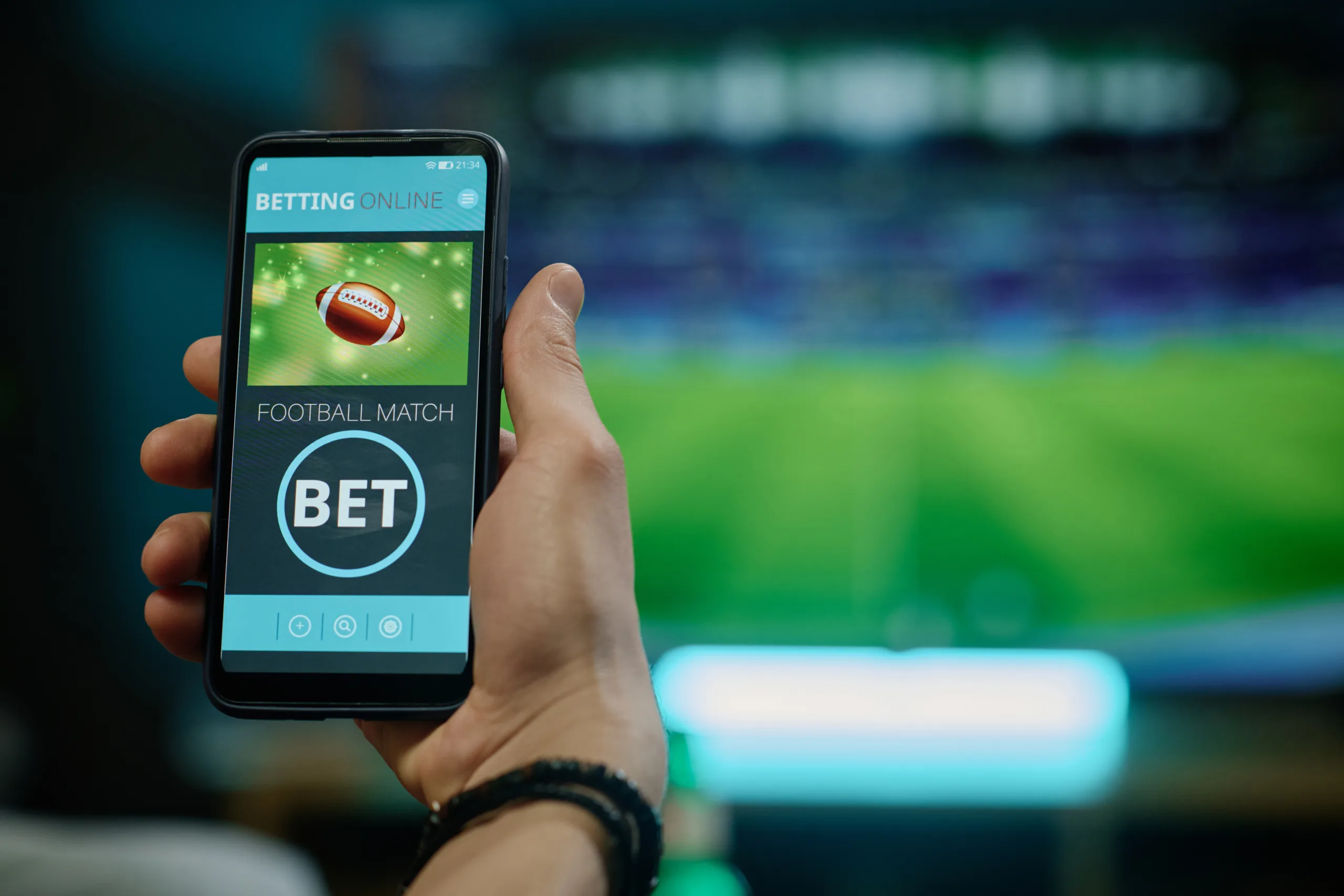 Unrecognizable Man Betting On Football Team